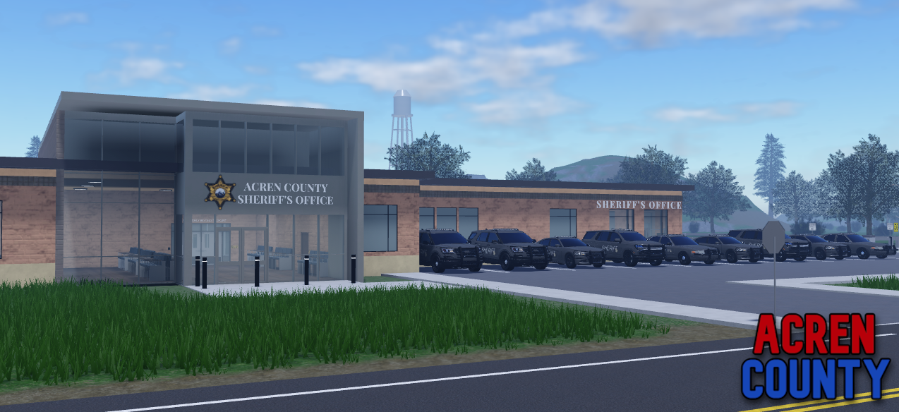 Sheriff's building with line up of patrol cars